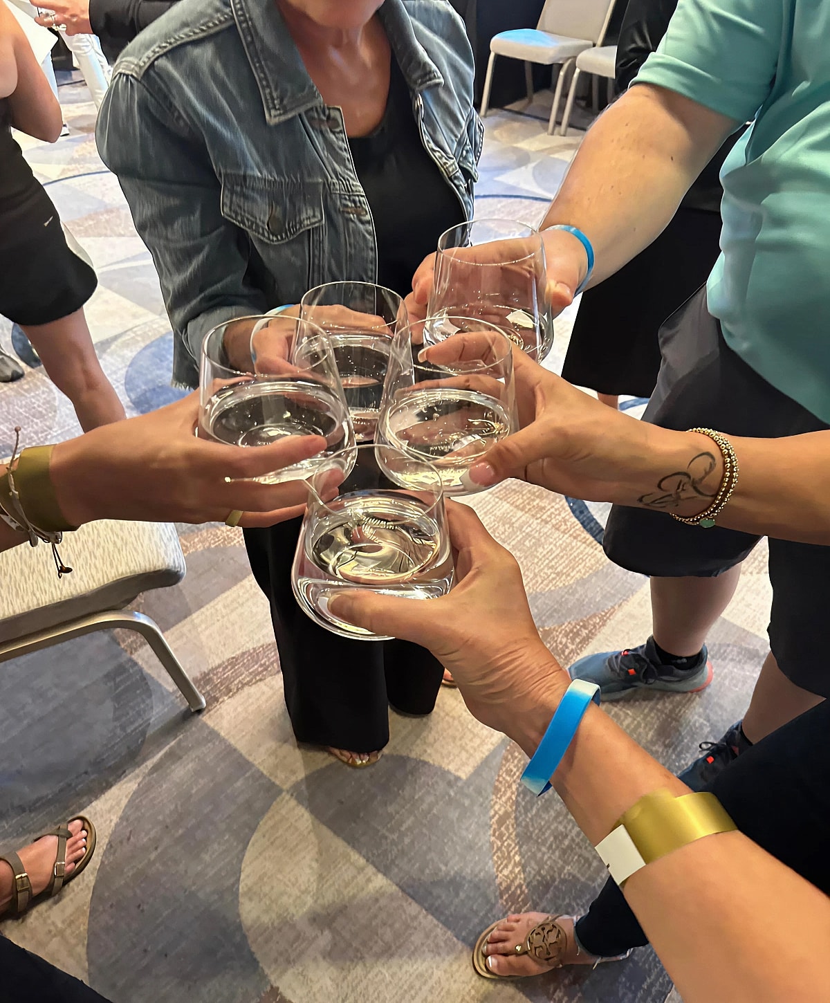 Cheers with multiple glasses of water.