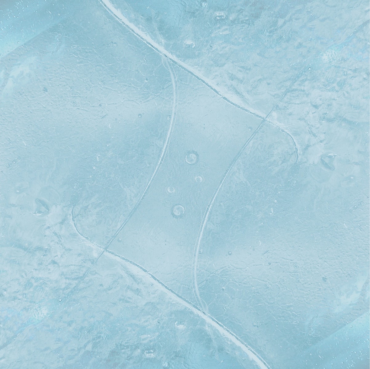 Textured blue ice or frozen water background.
