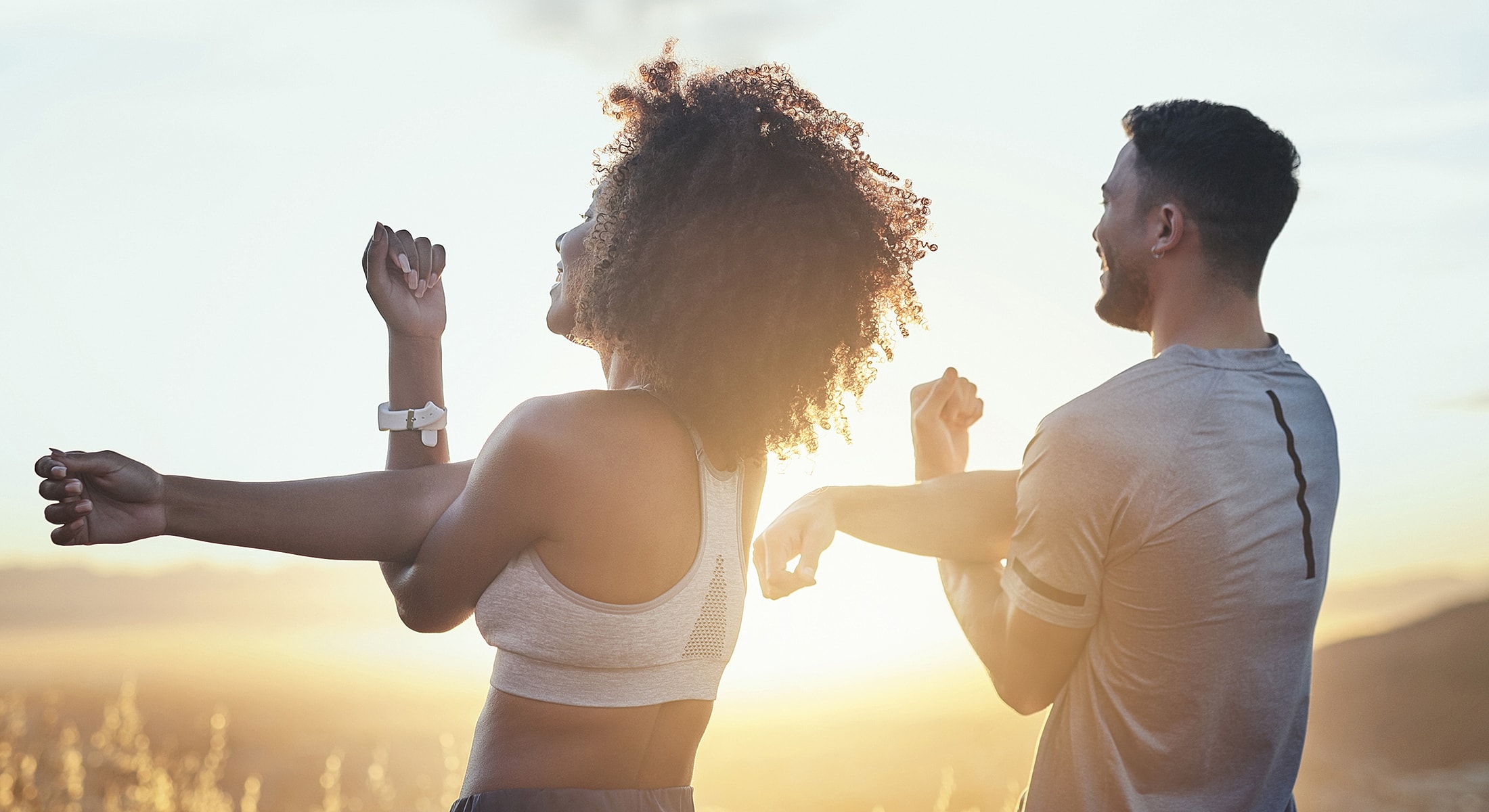 People exercising together at sunset.