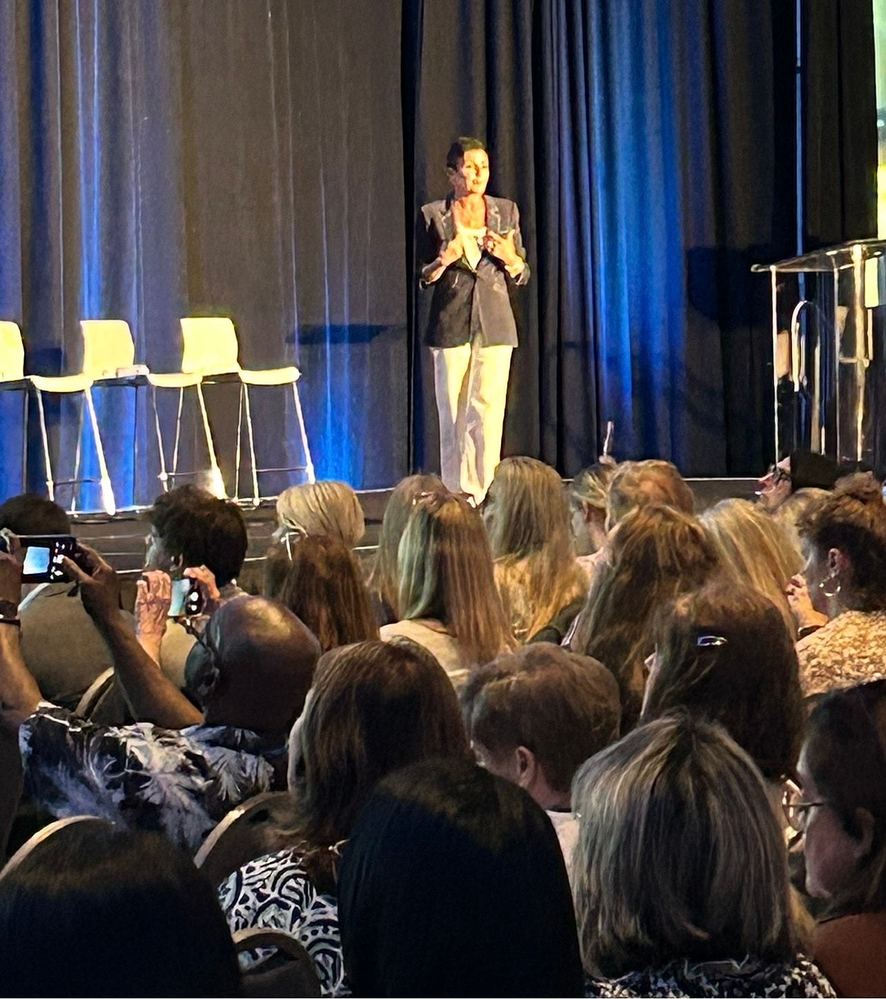 Women discussing health products at an expo.